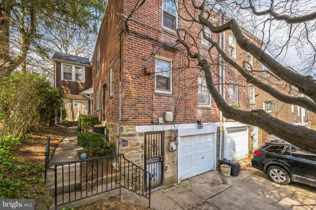 front view of a building with a tree