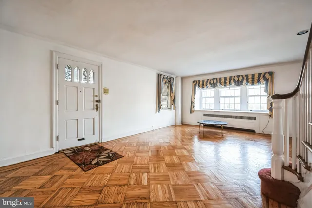 a view of empty room with window and couch