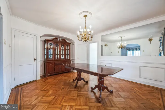 a room with chandelier and fireplace