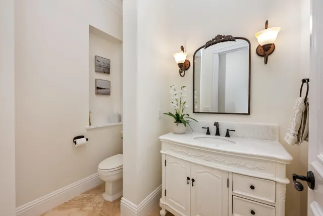 a living room with furniture and a flat screen tv with kitchen view
