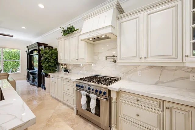 a dining room with furniture and large windows