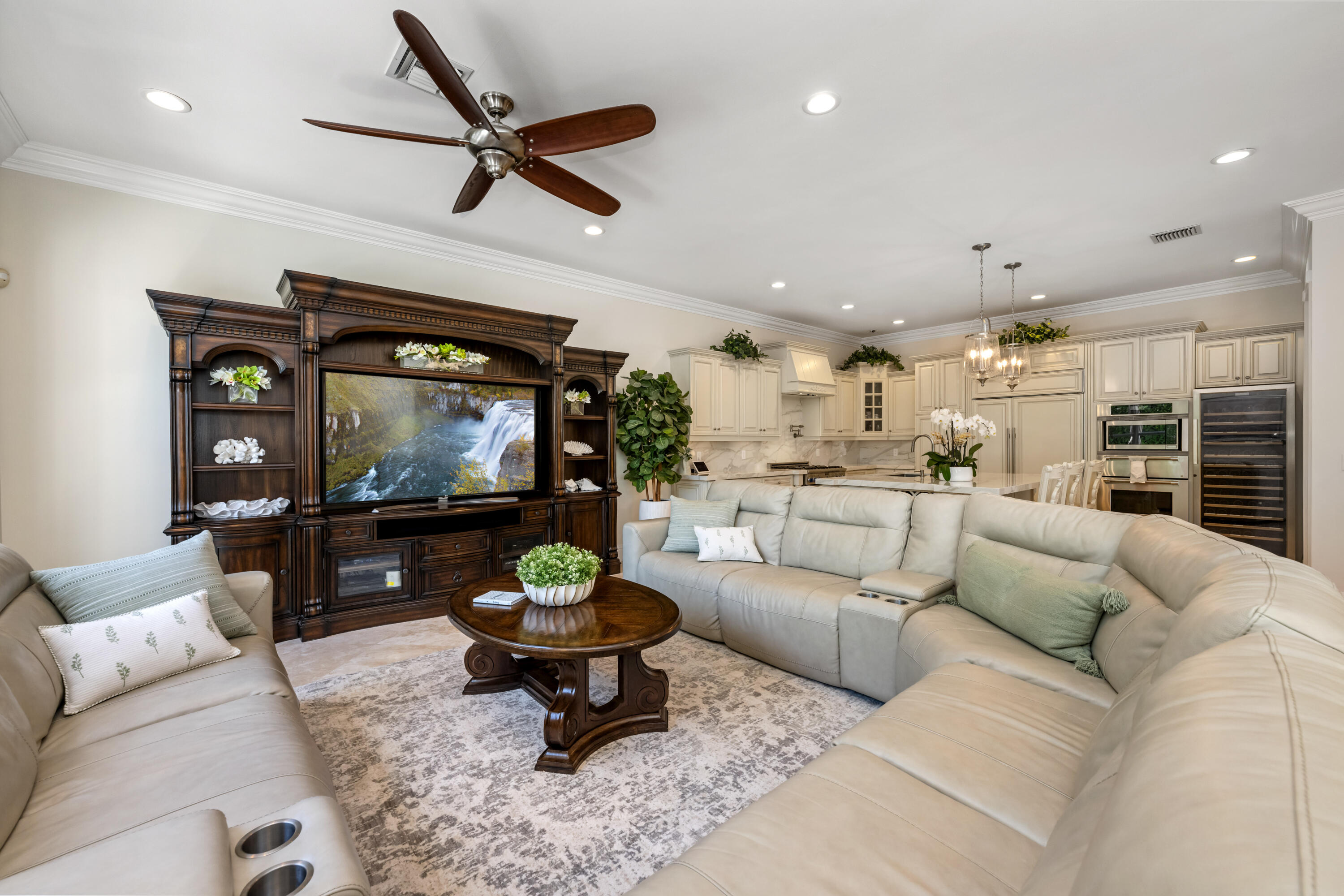 712 Northeast 71st Street Boca Raton, FL 33487 - Photo 28 of 97 a living room with furniture and a flat screen tv with kitchen view