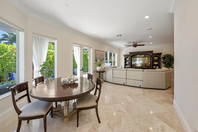a bedroom with a bed a chandelier and a window