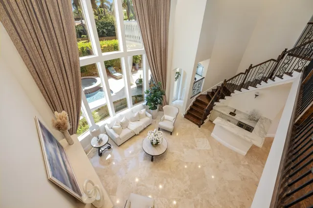 a bathroom with a granite countertop toilet a sink a mirror a shower and vanity