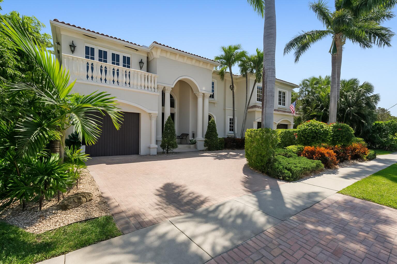 712 Northeast 71st Street Boca Raton, FL 33487 - Photo 4 of 97 a front view of a house with a yard and a garage
