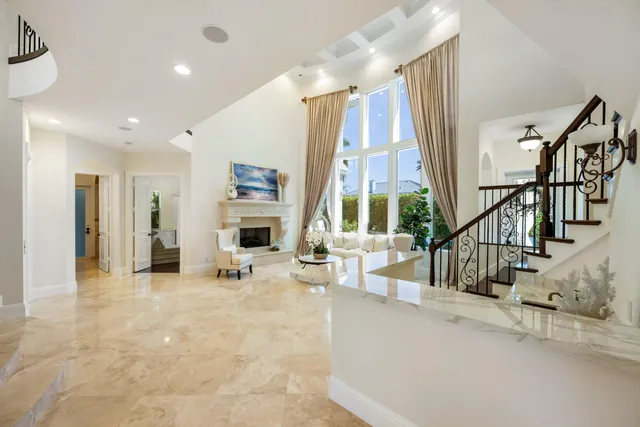 a dining room with furniture a chandelier and window