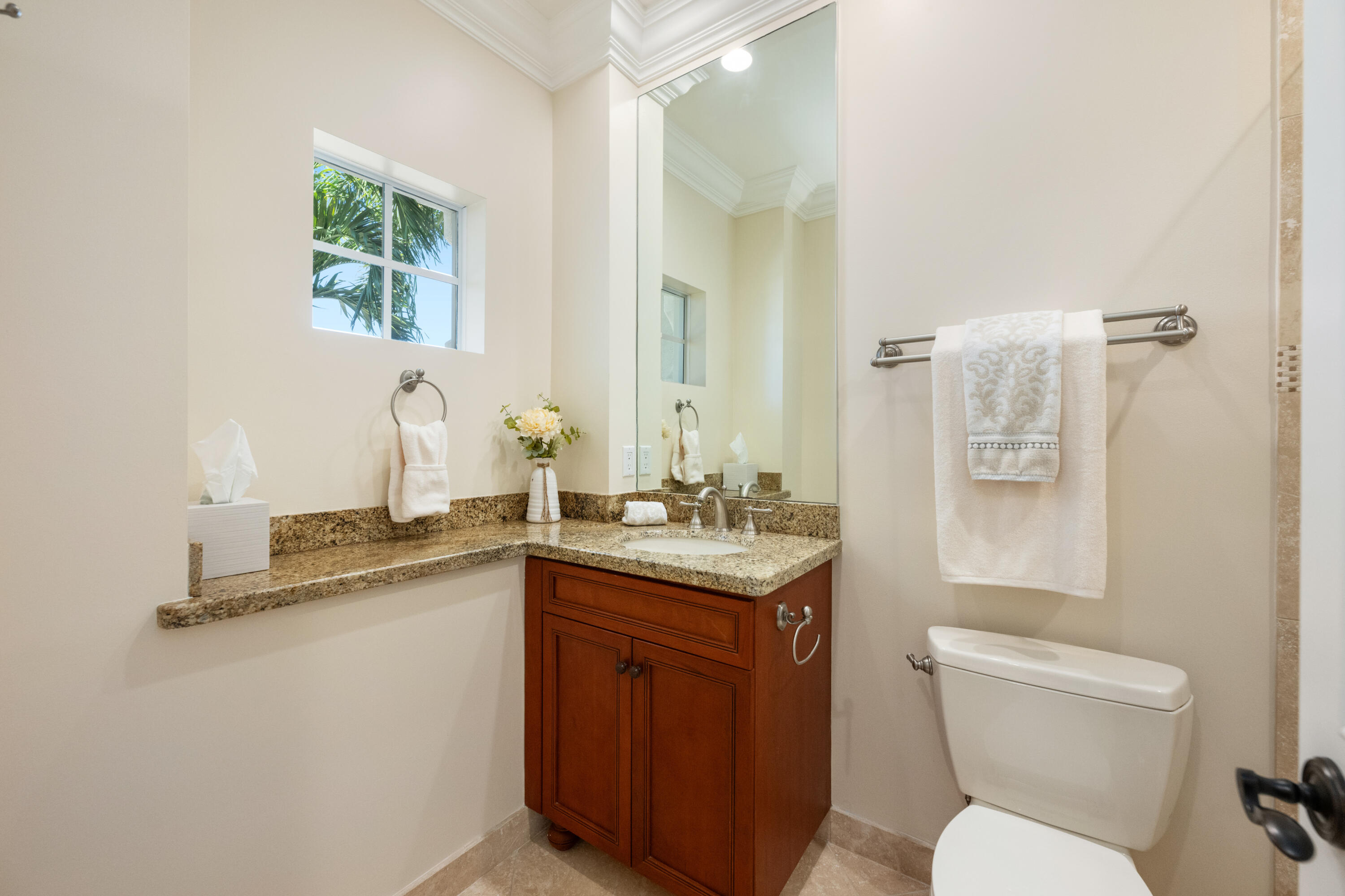 712 Northeast 71st Street Boca Raton, FL 33487 - Photo 63 of 97 a bathroom with a granite countertop toilet sink and mirror