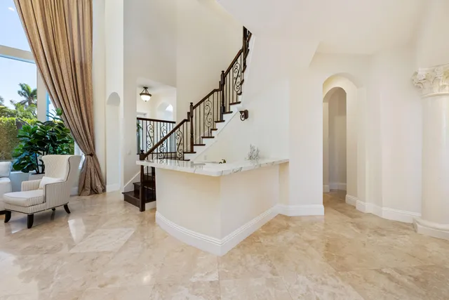 a kitchen with stainless steel appliances kitchen island granite countertop a stove a sink a dining table and chairs with wooden floor