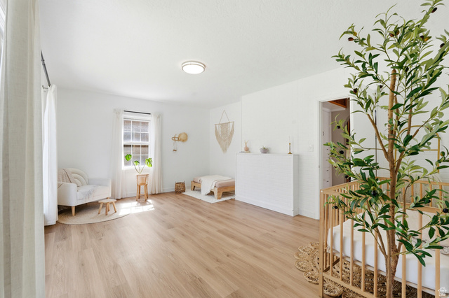 270 East 700 North Logan, UT 84321 - Photo 18 of 42 Bright interior space featuring light wood-finish flooring, white walls, and a window with white trim