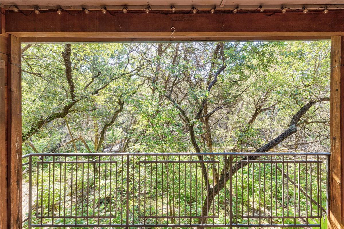 4711 Spicewood Springs Road, Unit 4222 Austin, TX 78759 - Photo 26 of 35 Relax on the balcony, enjoying a peaceful green tree-filled view.