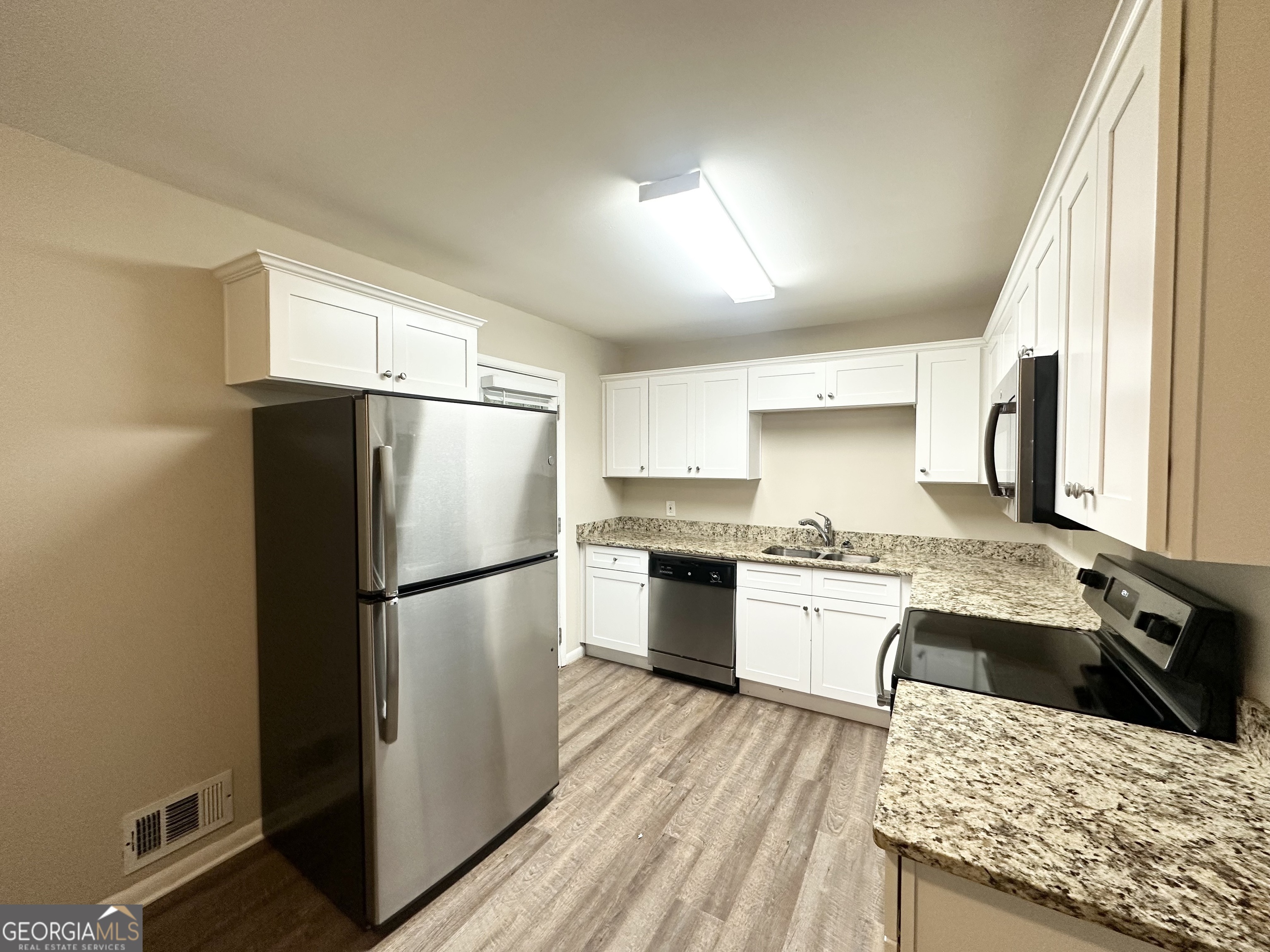 1519 Pine Glen Circle Decatur, GA 30035 - Photo 5 of 10 a kitchen with granite countertop a refrigerator stove top oven and sink