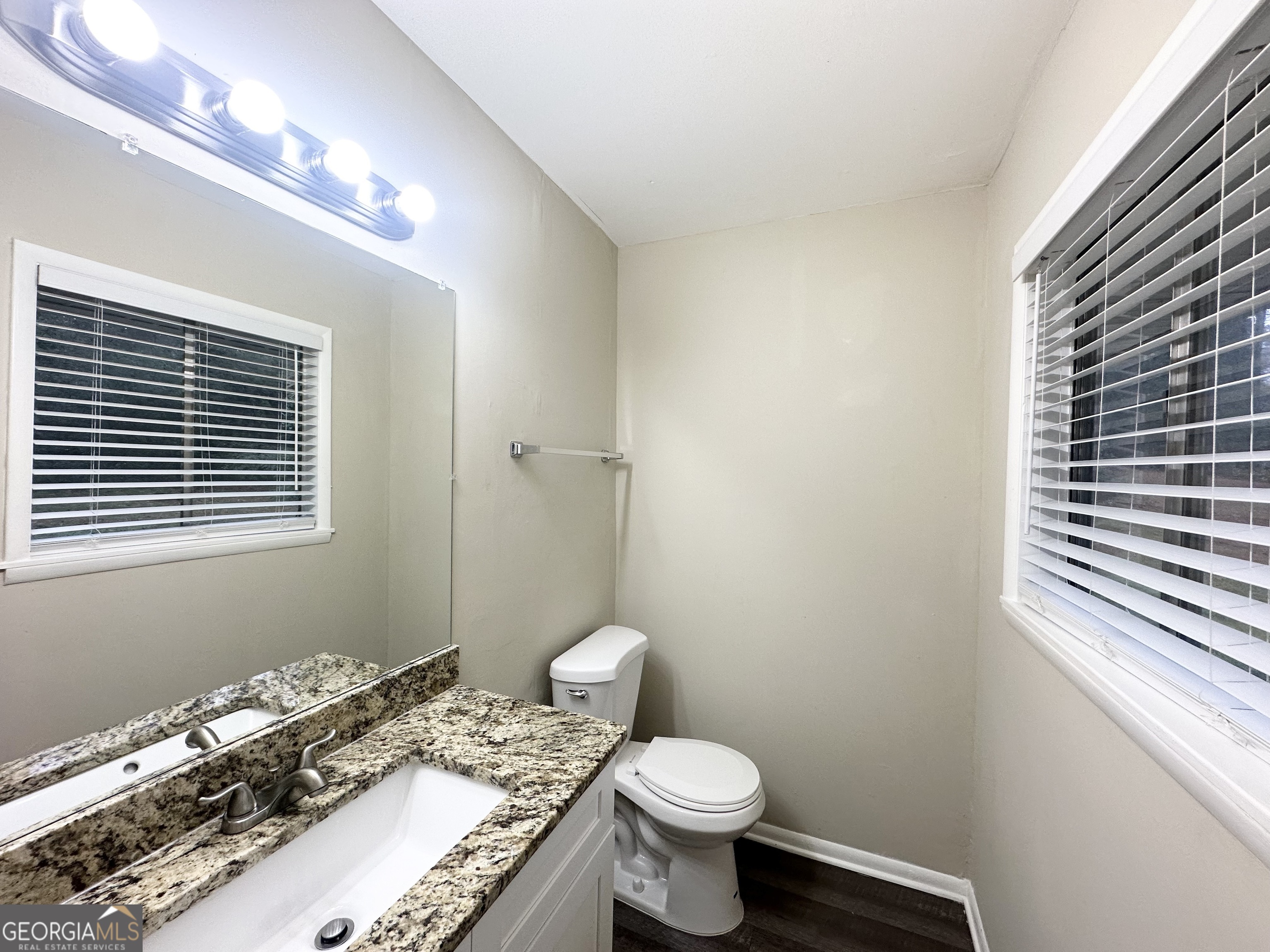 1519 Pine Glen Circle Decatur, GA 30035 - Photo 7 of 10 a bathroom with a granite countertop toilet sink and mirror