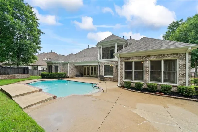 a front view of a house with yard and green space