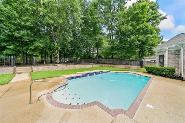 a view of swimming pool with a yard