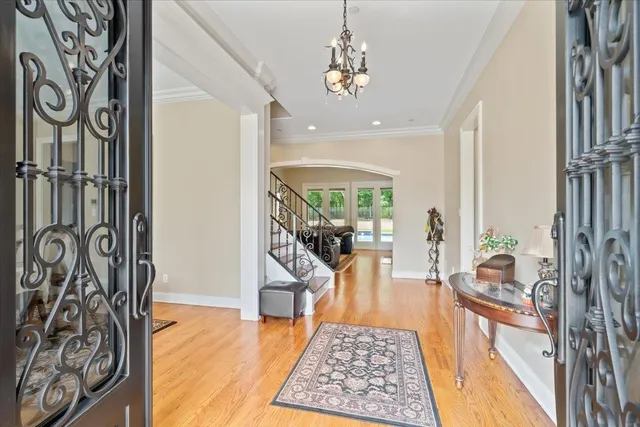 a view of hallway with wooden floor and stairs