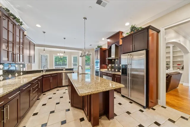 a kitchen with granite countertop a sink appliances and cabinets