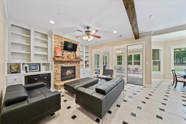 a living room with furniture and a floor to ceiling window