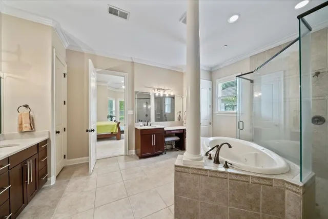 a spacious bathroom with a tub sink shower and mirror