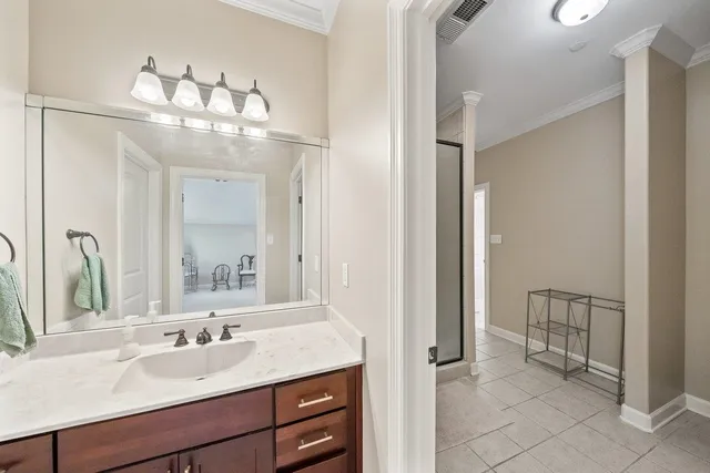 a spacious bedroom with a bed and a chandelier