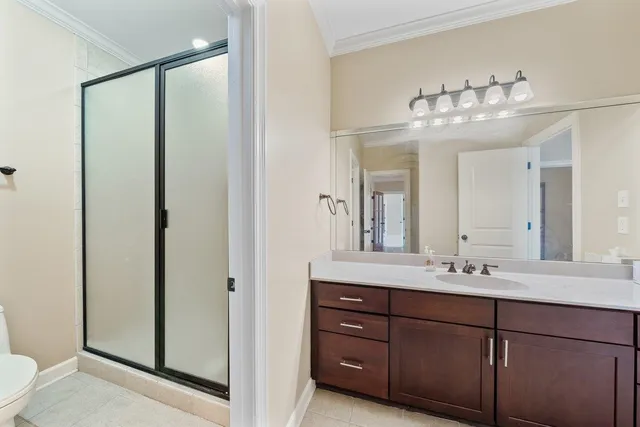 a bedroom with a bed dresser and a window