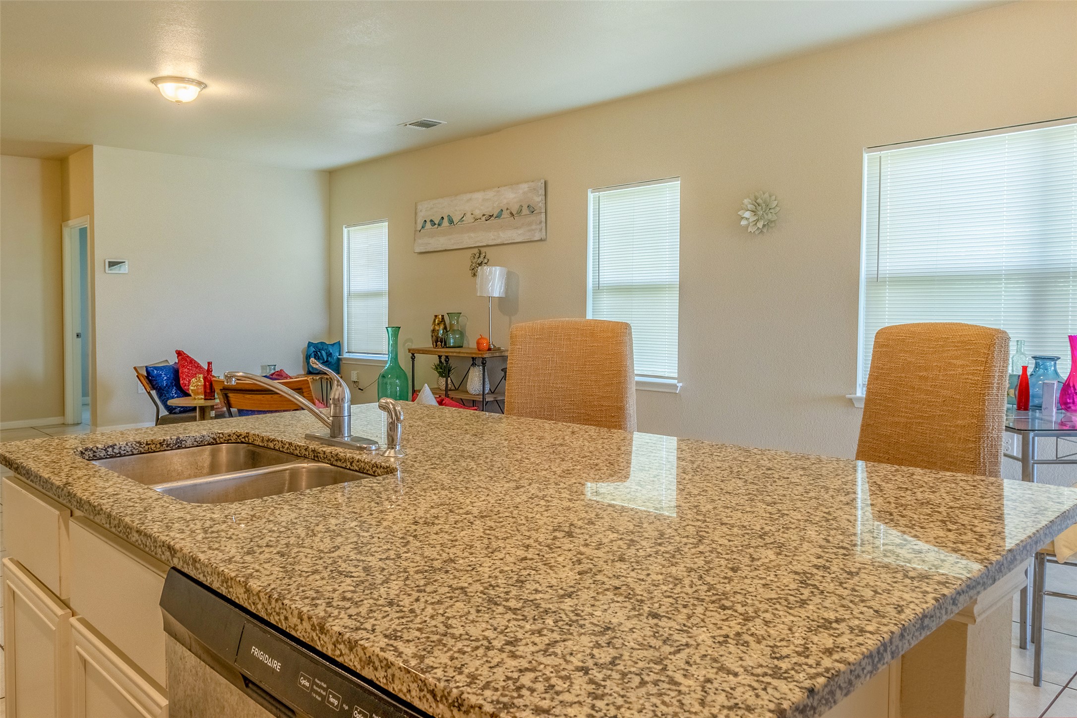 7225 Ranchito Drive Austin, TX 78744 - Photo 10 of 39 Granite counters and dual sinks define this inviting kitchen space.