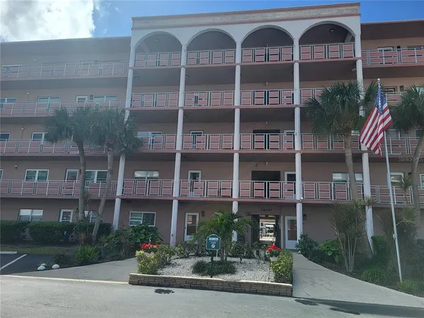 a front view of a building with garden