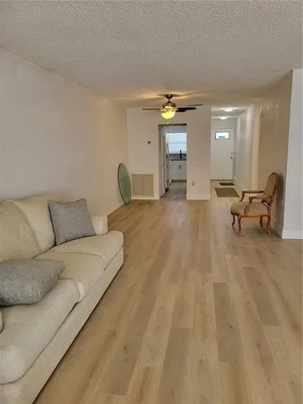 a living room with furniture and a lamp