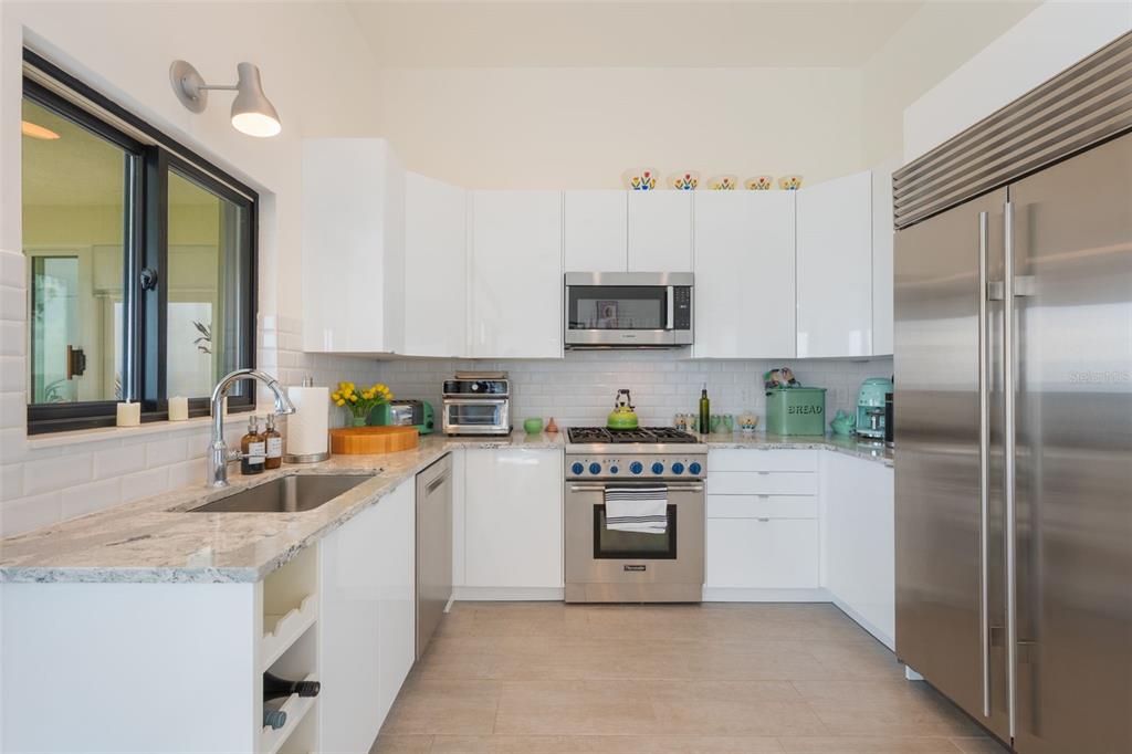 17640 Broad Street Montverde, FL 34756 - Photo 13 of 48 a kitchen with stainless steel appliances granite countertop a refrigerator a stove top oven a sink and dishwasher