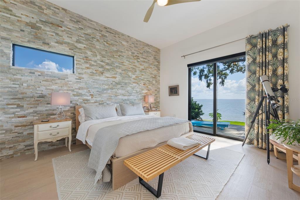 17640 Broad Street Montverde, FL 34756 - Photo 16 of 48 a bed sitting in a room next to a large window