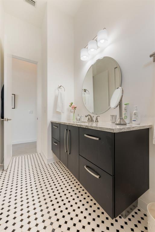 17640 Broad Street Montverde, FL 34756 - Photo 18 of 48 a bathroom with a sink vanity and a mirror