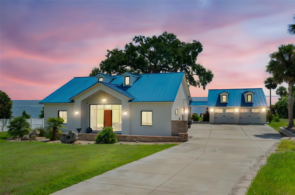 17640 Broad Street Montverde, FL 34756 - Photo 2 of 48 a front view of a house with a garden and plants