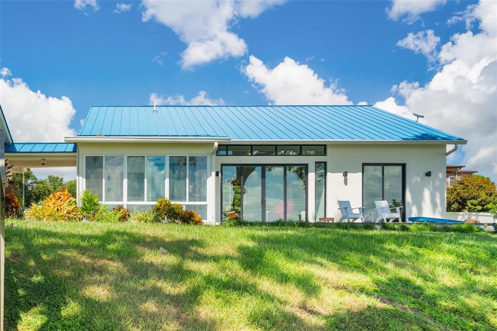 17640 Broad Street Montverde, FL 34756 - Photo 28 of 48 a front view of a house with a garden and porch