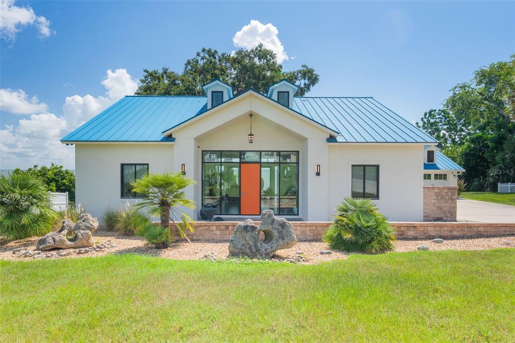 17640 Broad Street Montverde, FL 34756 - Photo 3 of 48 a front view of a house with garden