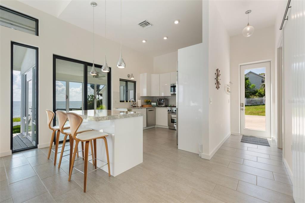 17640 Broad Street Montverde, FL 34756 - Photo 10 of 48 a kitchen with stainless steel appliances kitchen island granite countertop a refrigerator and cabinets