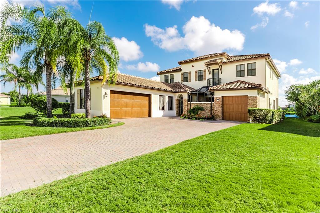 a front view of a house with a garden and trees