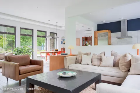 a living room with furniture potted plant and a window