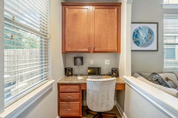 a room with a cabinets a sink and a stove next to a window