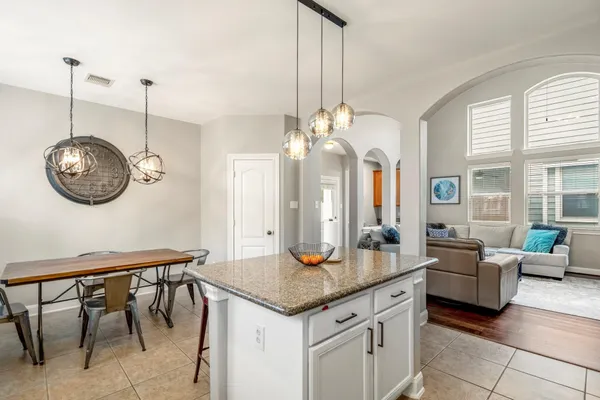 a kitchen with a table and chairs in it