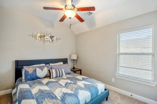 a bedroom with a large bed and a window