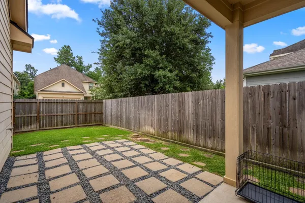 a view of a backyard with wooden fence