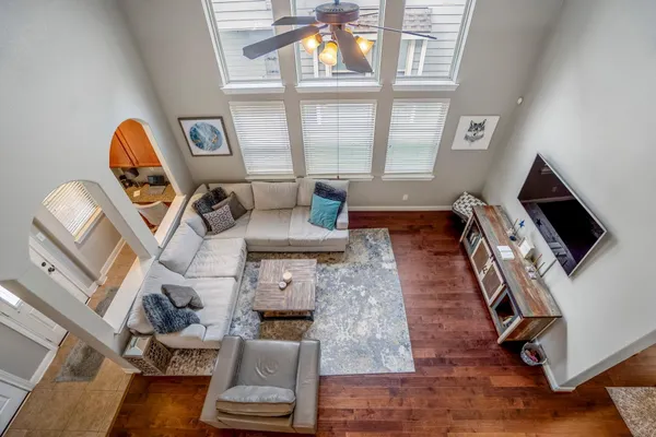 a view of a livingroom with furniture a flat screen tv and windows