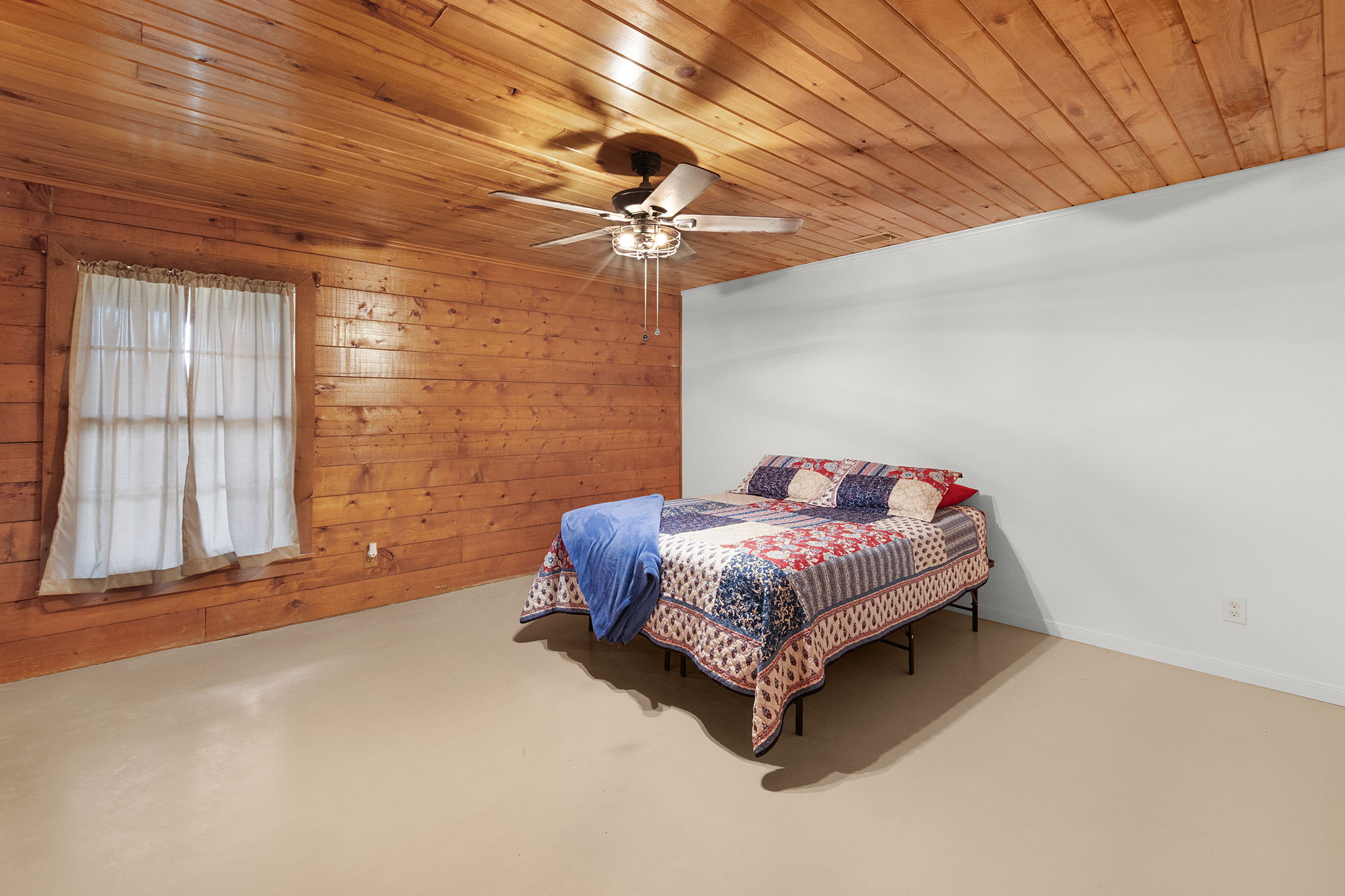 124 Old Mission Road Kempner, TX 76539 - Photo 19 of 40 a spacious bedroom with a bed and a chandelier