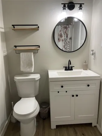 a bathroom with a toilet a sink and a mirror