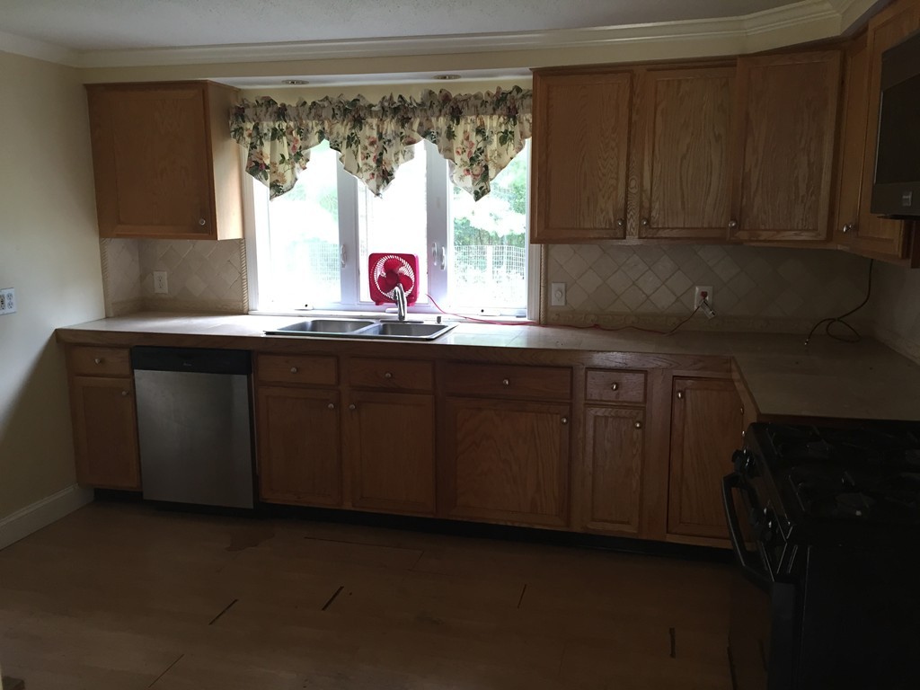 9 Kanehoe Court Townsend, MA 01474 - Photo 2 of 4 a kitchen with a sink cabinets and window