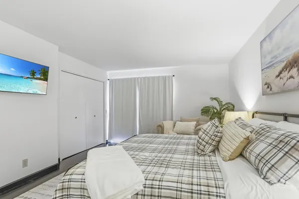 a bedroom with a bed and a window