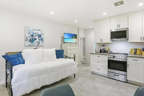 a bed room with a bed and a television