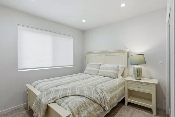 a bedroom with a bed and a night stand