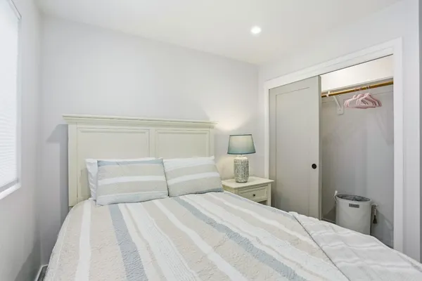 a bedroom with a bed and a night stand