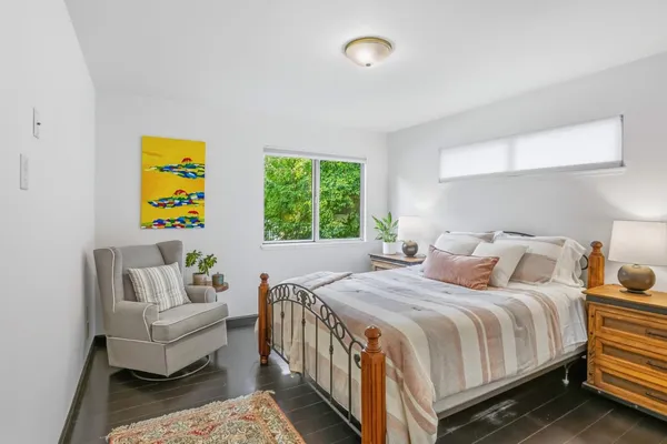 a bedroom with a bed and a couch