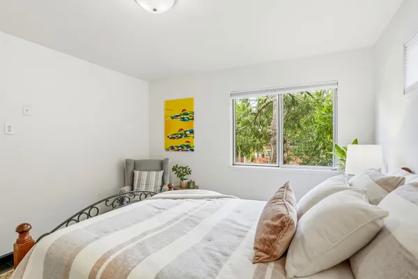 a bedroom with a bed and a window